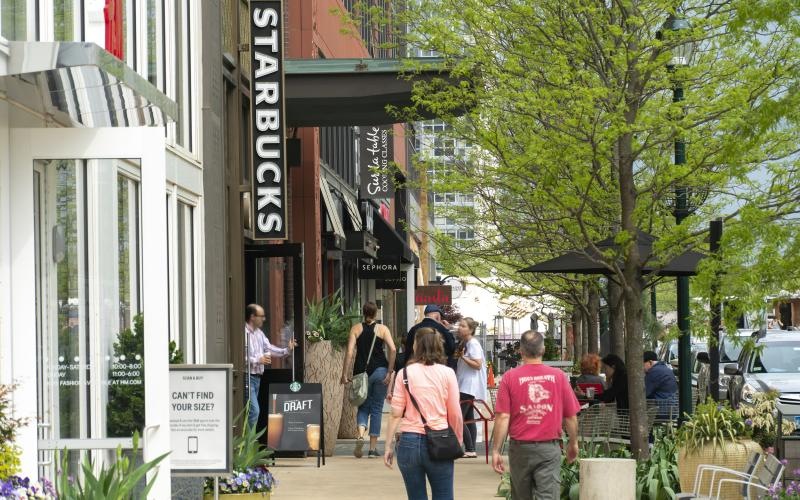 people walking on a sidewalk