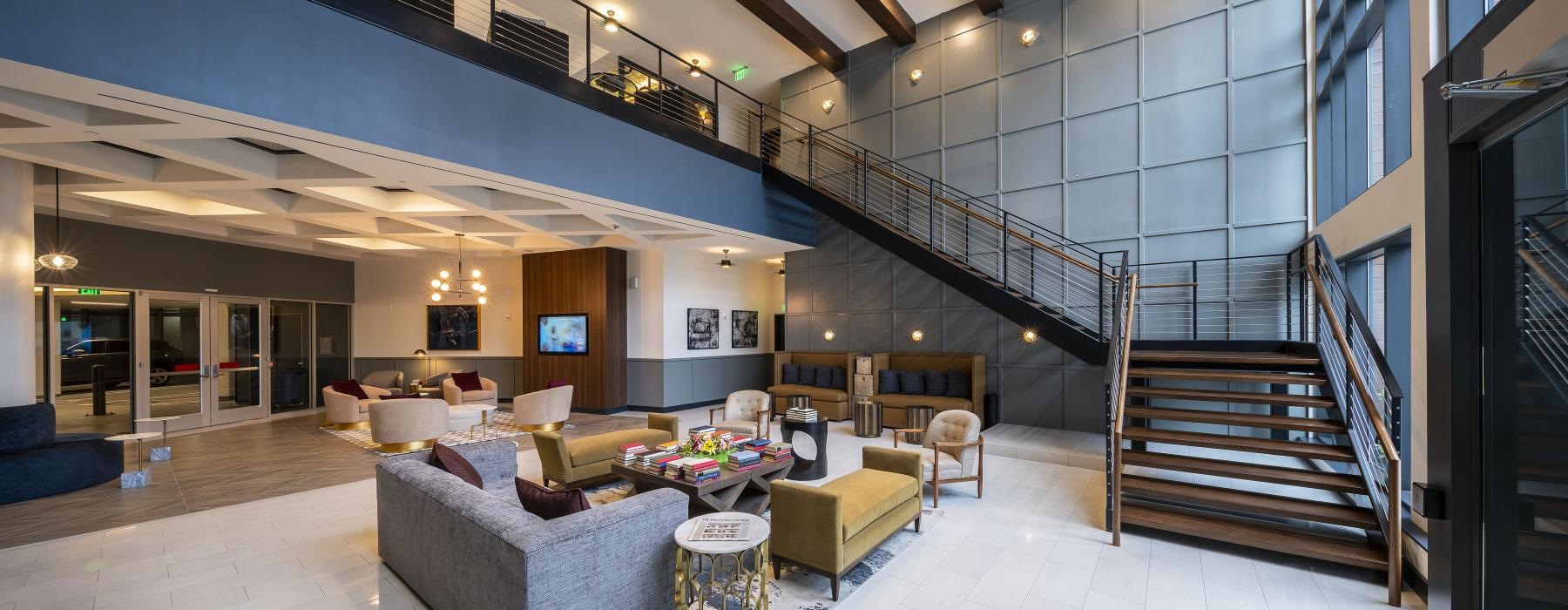 a large room with seating with a staircase